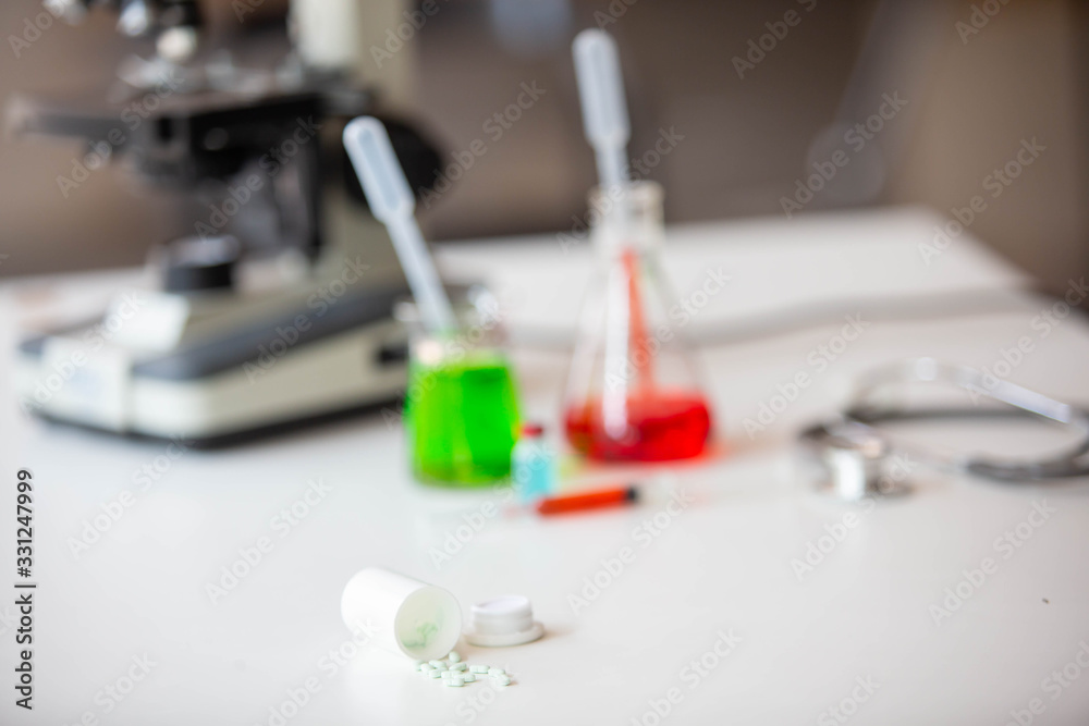 The doctor is testing a sample of biological tubes contaminated by Corona-virus Covid 19 and searching for a vaccine or Syrup against the virus. In the laboratory and film samples of infected lung The doctor is testing a sample of biological tubes contaminated by Corona-virus Covid 19 and searching for a vaccine or Syrup against the virus. In the laboratory and film samples of infected lung