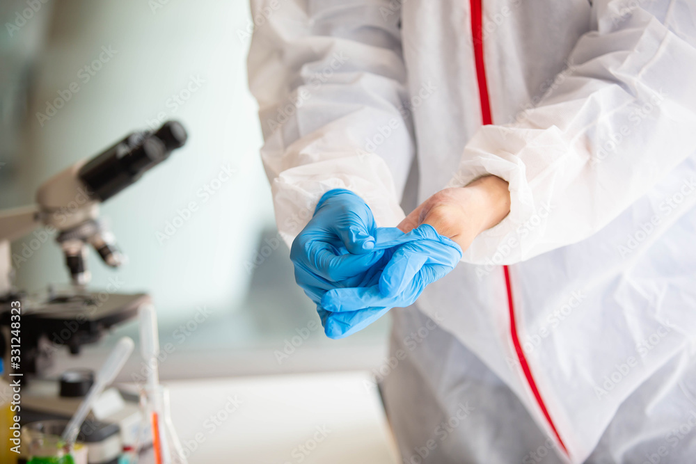 The doctor is testing a sample of biological tubes contaminated by Corona-virus Covid 19 and searching for a vaccine or Syrup against the virus. In the laboratory and film samples of infected lung The doctor is testing a sample of biological tubes contaminated by Corona-virus Covid 19 and searching for a vaccine or Syrup against the virus. In the laboratory and film samples of infected lung