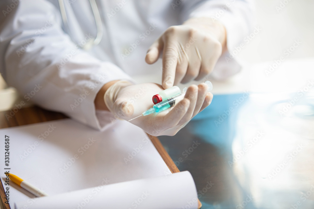 The doctor is testing a sample of biological tubes contaminated by Corona-virus Covid 19 and searching for a vaccine or Syrup against the virus. In the laboratory and film samples of infected lung The doctor is testing a sample of biological tubes contaminated by Corona-virus Covid 19 and searching for a vaccine or Syrup against the virus. In the laboratory and film samples of infected lung