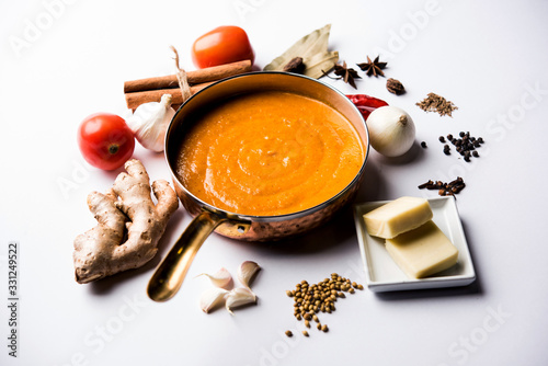 North Indian basic Curry for paneer butter masala or chicken makhanwala recipe shown with ingredients, served in a bowl. selective focus photo