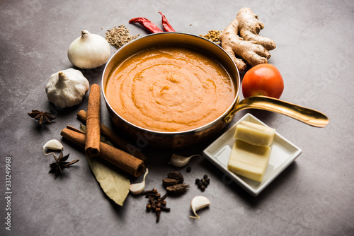 North Indian basic Curry for paneer butter masala or chicken makhanwala recipe shown with ingredients, served in a bowl. selective focus photo