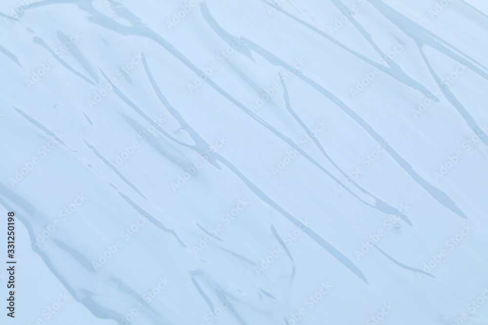 Obraz premium Sample of transparent cosmetic gel as background, closeup