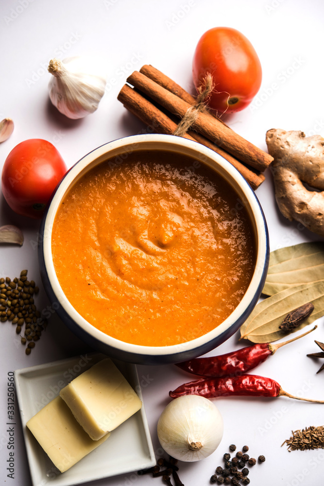 North Indian basic Curry for paneer butter masala or chicken makhanwala recipe shown with ingredients, served in a bowl. selective focus North Indian basic Curry for paneer butter masala or chicken makhanwala recipe shown with ingredients, served in a bowl. selective focus
