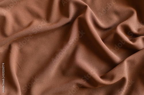 Soft light brown folded fabric for background.