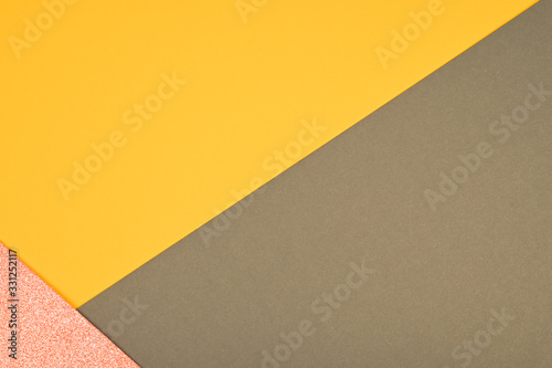 Color paper composition. Top view background, minimal concept, flat lay: taupe, goldenrod and pink glitter