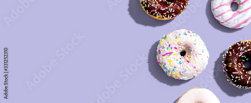 Fotografie Collection of delicious donuts overhead view flat lay