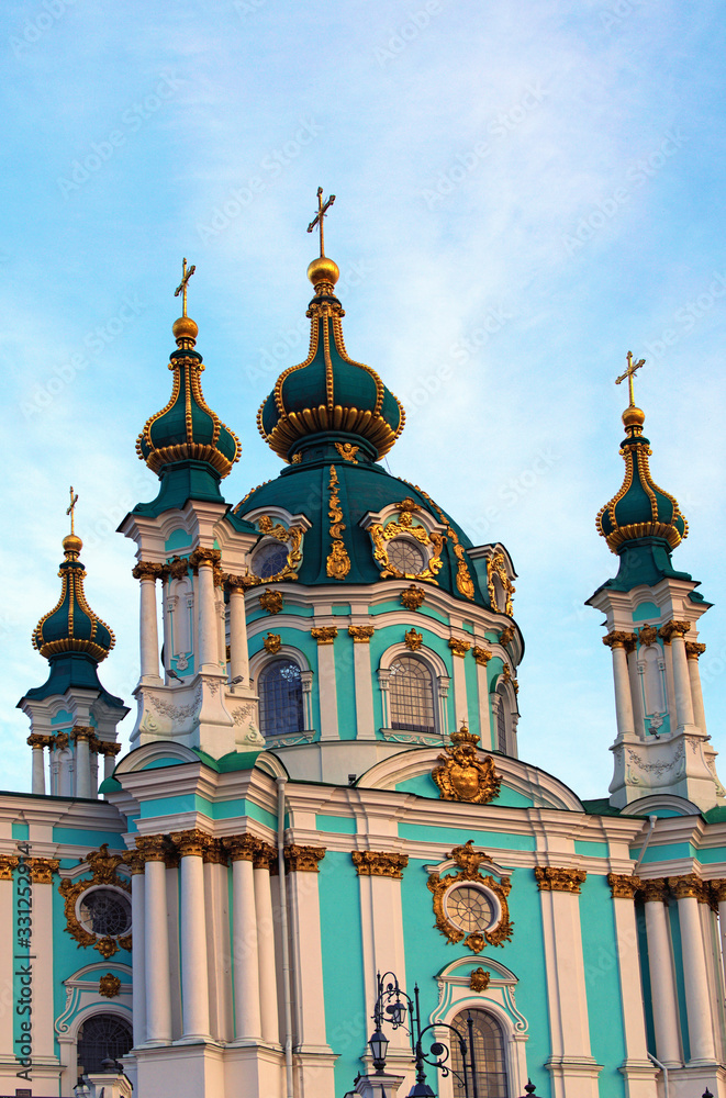 Scenic close-up voew of ancient Saint Andrew Church against blue sky at sunny spring morning. Famous touristic place and travel destination in Kyiv, Ukraine