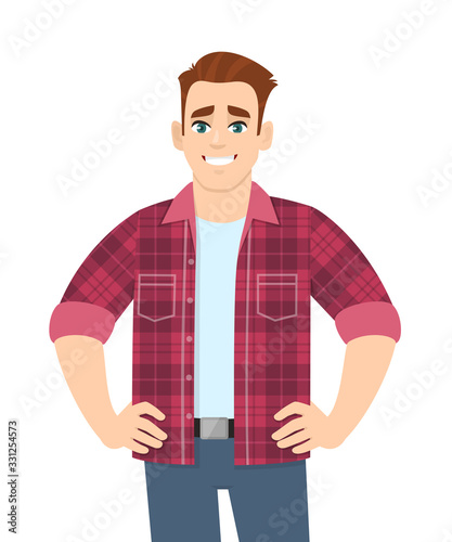 Happy young man standing and holding hands on hips. Stylish trendy person wearing casual fashion costume. Male character design illustration. Modern lifestyle concept in vector cartoon style.