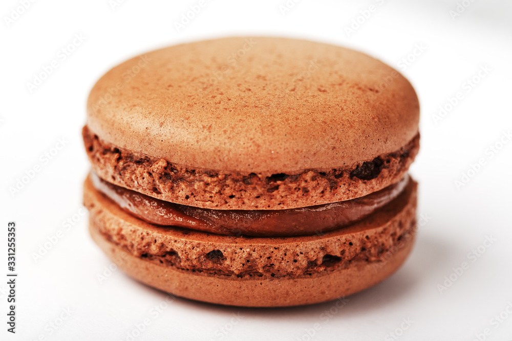 Chocolate macaroni cookies on a white background with brown filling, isolated. Chocolate macaroni cookies on a white background with brown filling, isolated.