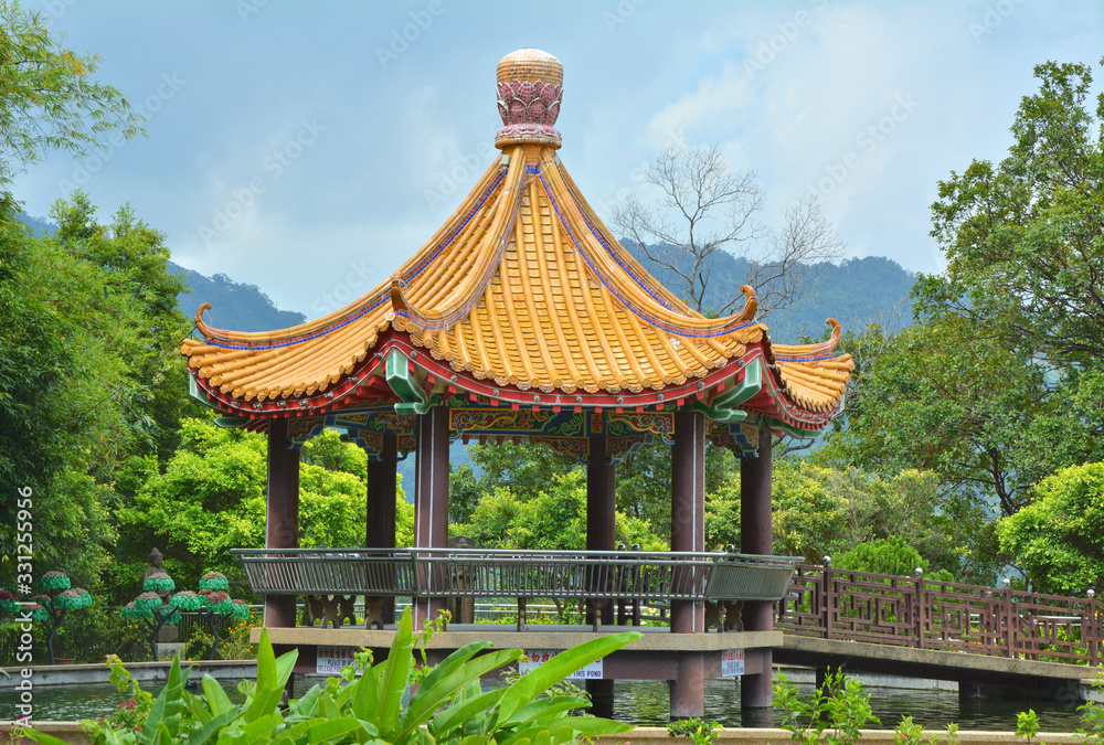 Fototapeta premium Pavilion over pond in Kek Lok Si temple garden