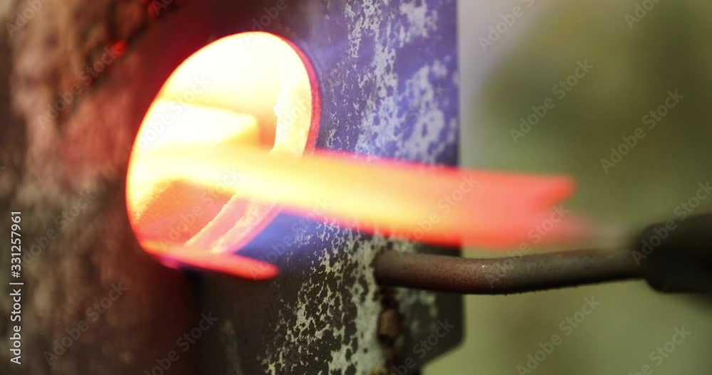 Bladesmith putting blades into kiln