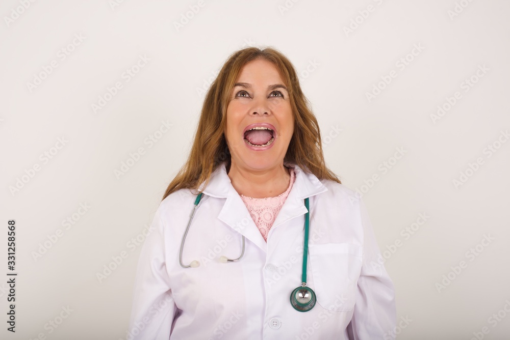 Stressful doctor woman screams in panic, closes eyes in terror, keeps hands on head, finds out terrified news or disaster about best friend, can't believe it. People, stress, annoyance Stressful doctor woman screams in panic, closes eyes in terror, keeps hands on head, finds out terrified news or disaster about best friend, can't believe it. People, stress, annoyance