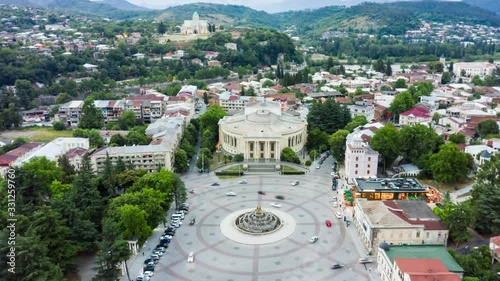 Summer Hyperlapse of the city of Kutaisi, Georgia. David Agmashenebeli Square, Theater named after Lado Meskhishvili and old houses with Red roofs. Mountains in the distance. photo