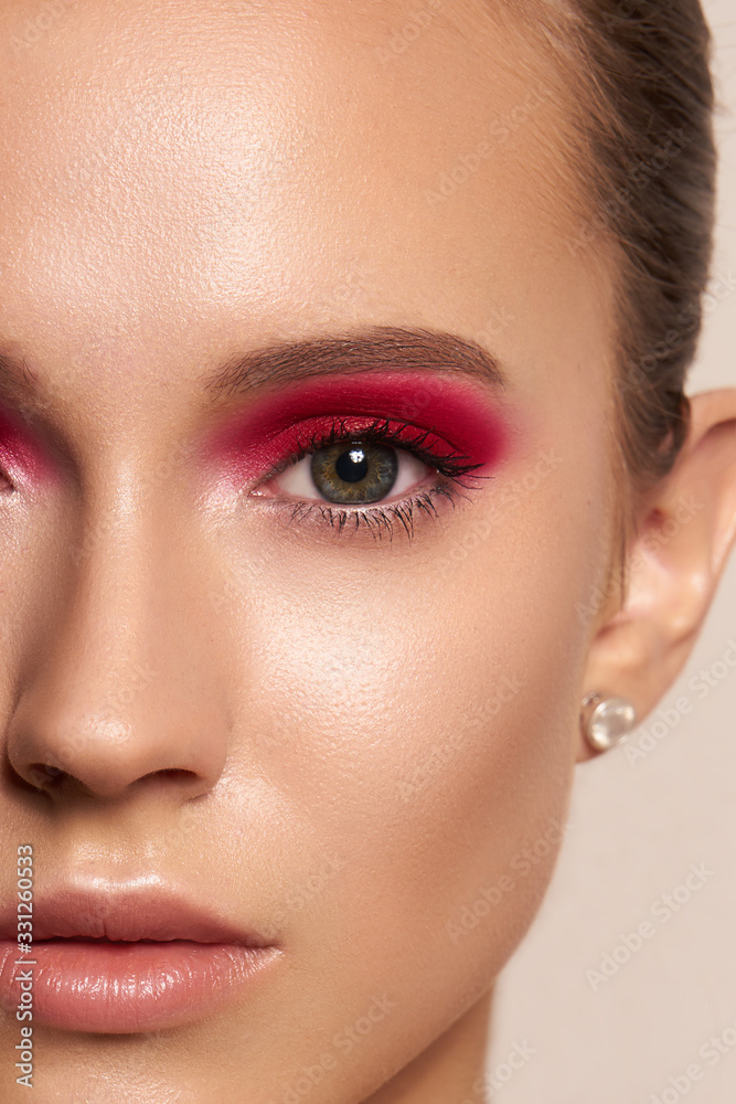 Close-up young girl with pink eyeshadows and clean skin