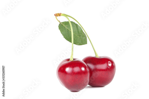 Sweet cherries with green leaf isolated on white background