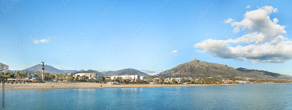 Panoramic view of Bay Banus Beach , in luxury location near Banus Bay, Marbella. The statue 