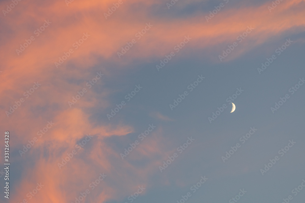 Beautiful colorful clouds in the sky with a crescent moon Beautiful colorful clouds in the sky with a crescent moon