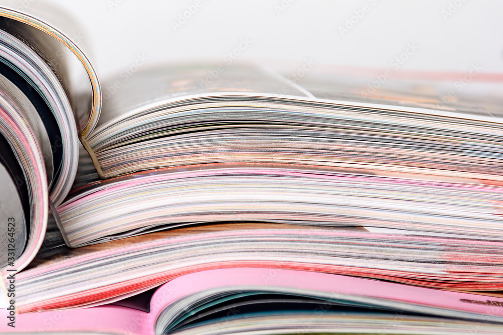 Colorful pages of an open magazine, close up. Selective focus. Colorful pages of an open magazine, close up. Selective focus.