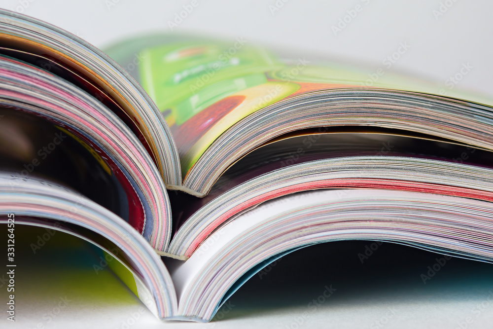 Colorful pages of an open magazine, close up. Selective focus. Colorful pages of an open magazine, close up. Selective focus.
