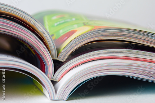 Colorful pages of an open magazine, close up. Selective focus.