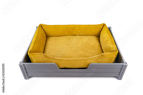 Bed for a dog or cat in gray on a wooden stand with legs on a white background. Isolate