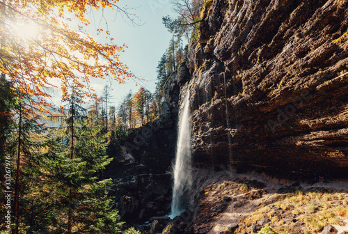 Fantastic sunny landscape. Pericnik waterfall in Slovenian Julian Alps in autumn under sunlight. Picture of wild area. Amazing nature Scenery. popular travel destination.