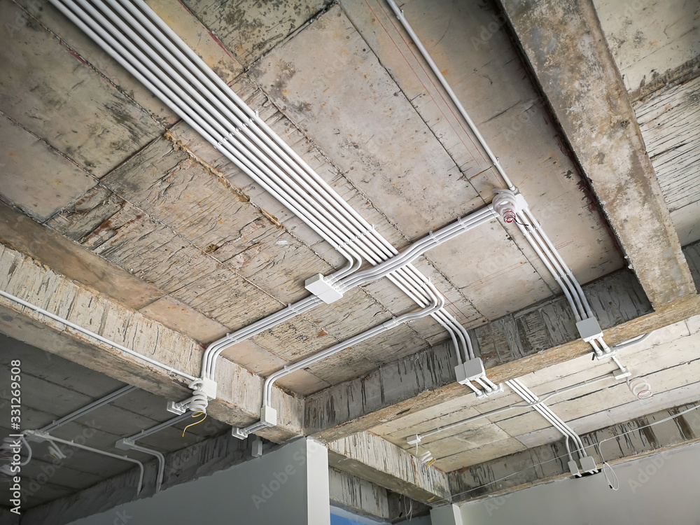 Installation of electrical wiring on the ceiling.Electrical cable system installation. Stock