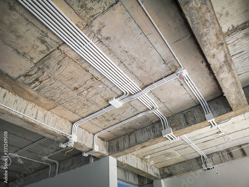 Installation of electrical wiring on the ceiling.Electrical cable system installation.