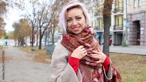 Young beautiful woman turns around and smiles while looking at the camera.