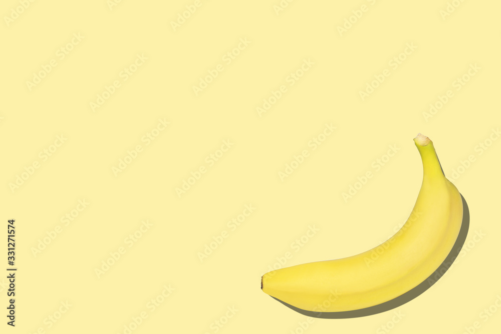 Sweet bananas on the yellow background with copyspace Sweet bananas on the yellow background with copyspace