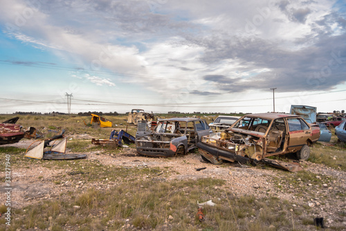 Old damaged cars in the junkyard. Car graveyard.