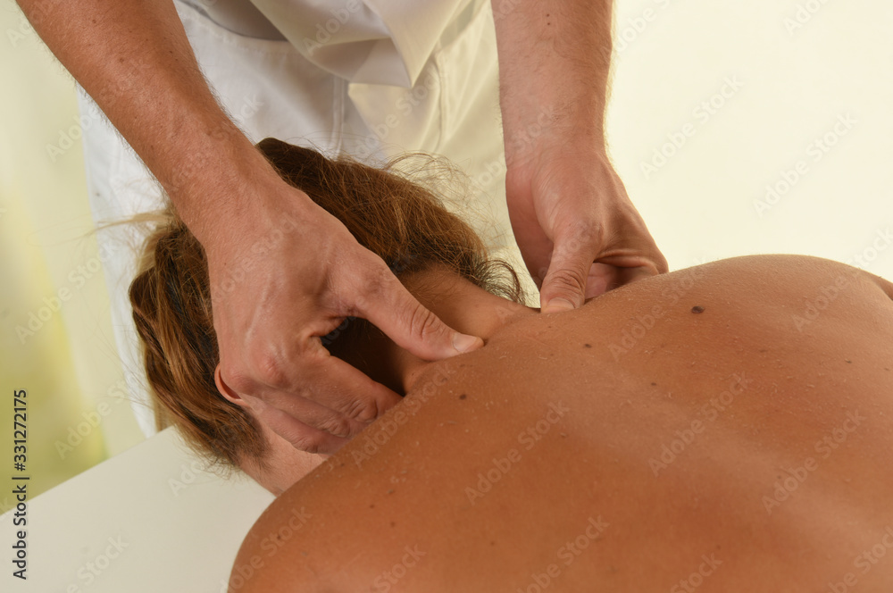 Masseur doing massage on woman body in the spa salon; Masseur doing massage on woman body in the spa salon;