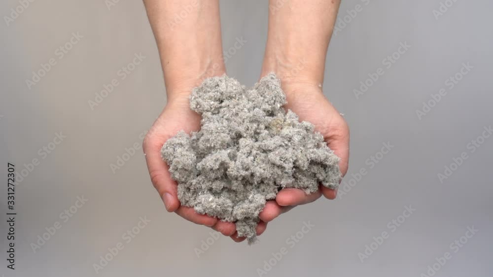 Hands holding eco-friendly cellulose insulation for walls for floors recycled newsprint warm house heat preservation and energy saving