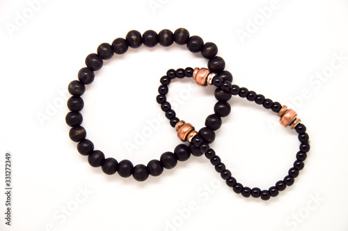 Black pearl bracelets on a white table board