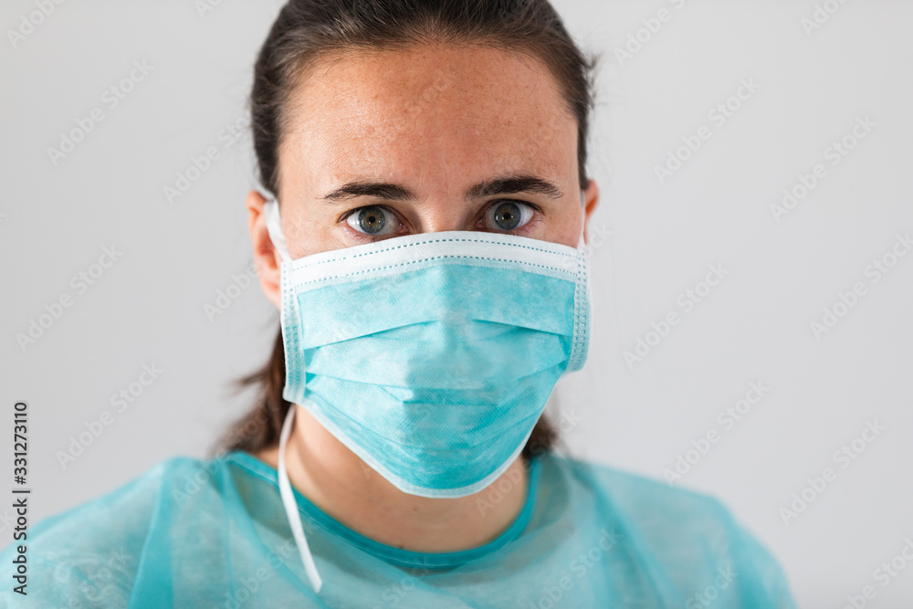 Young female doctor wearing protective mask against coronavirus. Medical personal protection equipment. Young female doctor wearing protective mask against coronavirus. Medical personal protection equipment.