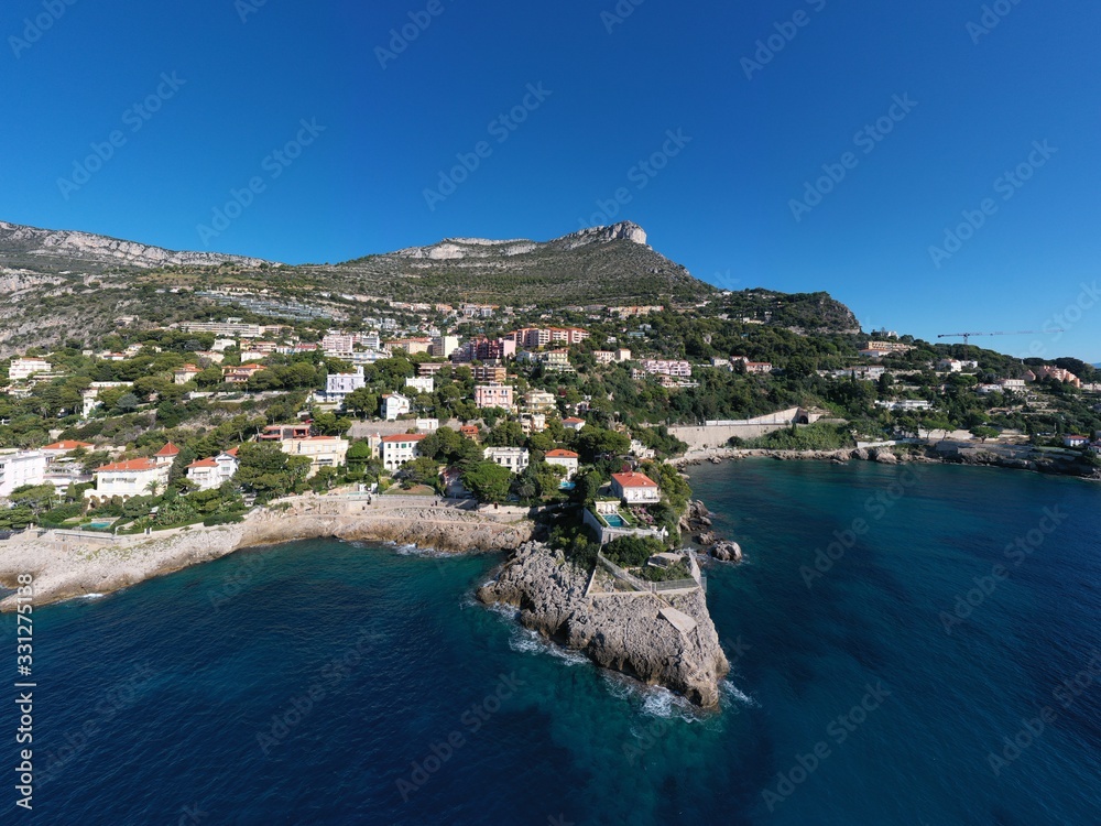 France, Cote Dazur, Beaulieu, 02 October 2019: Aerial view of French Riviera's terraces of expensive country houses and estates, palm trees, pools, stony coast, Chaise lounges