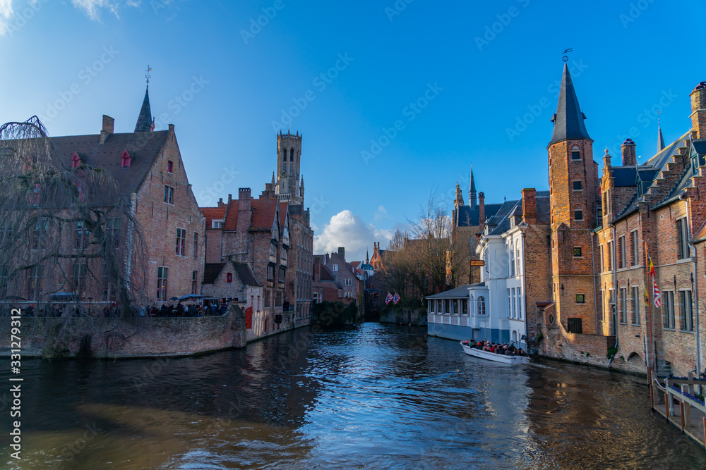 Spring scenery with gothic style houses of Sint-Janshospitaal and water canal in medieval belgian city from Flanders