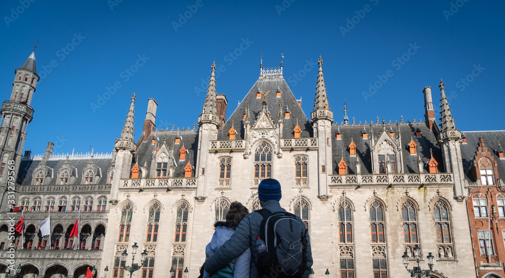 Fototapeta premium Caouple looking at Historium building in Bruges, Belgium