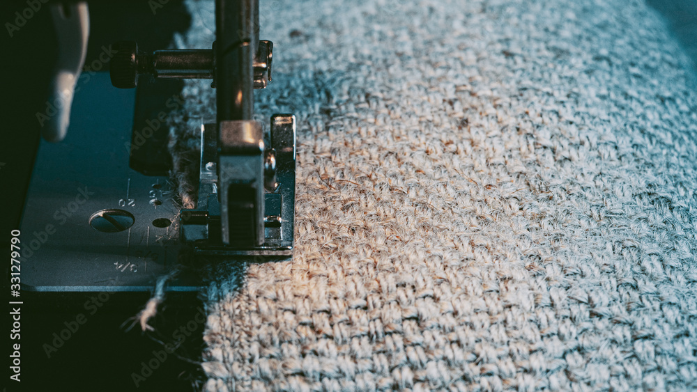 A Sewing Machine Sews Burlap Fabric. Sewing Hemp Fabric Clothing. Close-Up Macro Shot. Sewing Still Life. High Quality Photo A Sewing Machine Sews Burlap Fabric. Sewing Hemp Fabric Clothing. Close-Up Macro Shot. Sewing Still Life. High Quality Photo