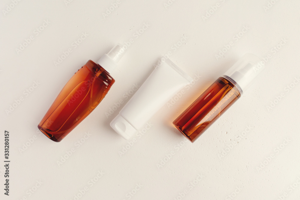 Summer sunscreen. Set of cosmetic bottles on a light background. Place for text. Copyspase. Summer sunscreen. Set of cosmetic bottles on a light background. Place for text. Copyspase.