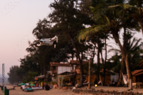 A DJI MAVIC MINI drone being flown at Agonda Beach in Goa, India. Latest drones and technology. Photography and Videography drones