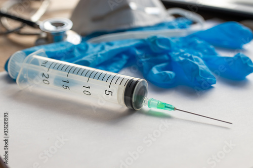 syringe with gloves and medical protection mask photo