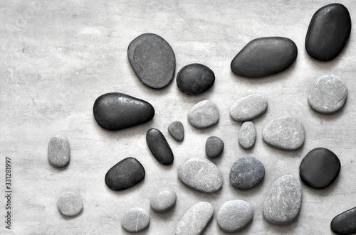 Flat lay composition with spa stones on grey background.
