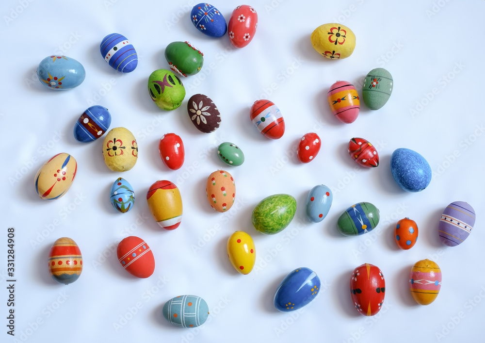 multicolored wooden eggs on white background multicolored wooden eggs on white background