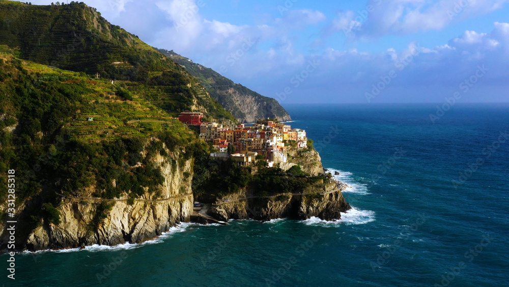 Village of Manarola in aerial view, Cinque Terre coast of Italy. Manarola is a small town in the province of La Spezia, in Liguria, in northern Italy and one of the Cinque Terre attractions for touris