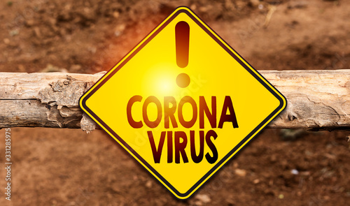 Road sign indicating coronavirus on treen trunk 