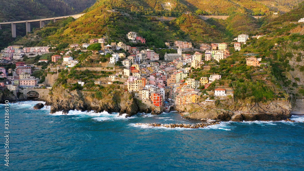 Aerial view of Riomaggiore Cinque Terre. This is a traditional and colorful fishing village near a cliff on the Mediterranean Sea, located on the Ligurian coast in Italy.