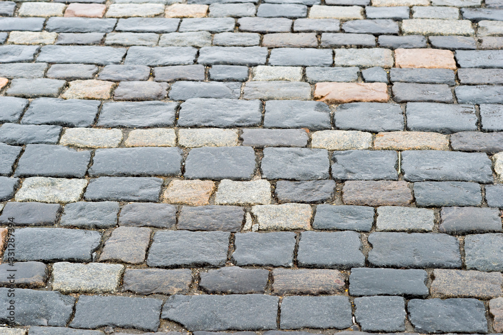 Old paving stones close- up of rectangular stone bricks. Textured background