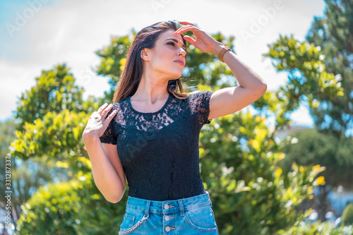Street style  a brunette enjoying the sun in a black lace t-shirt