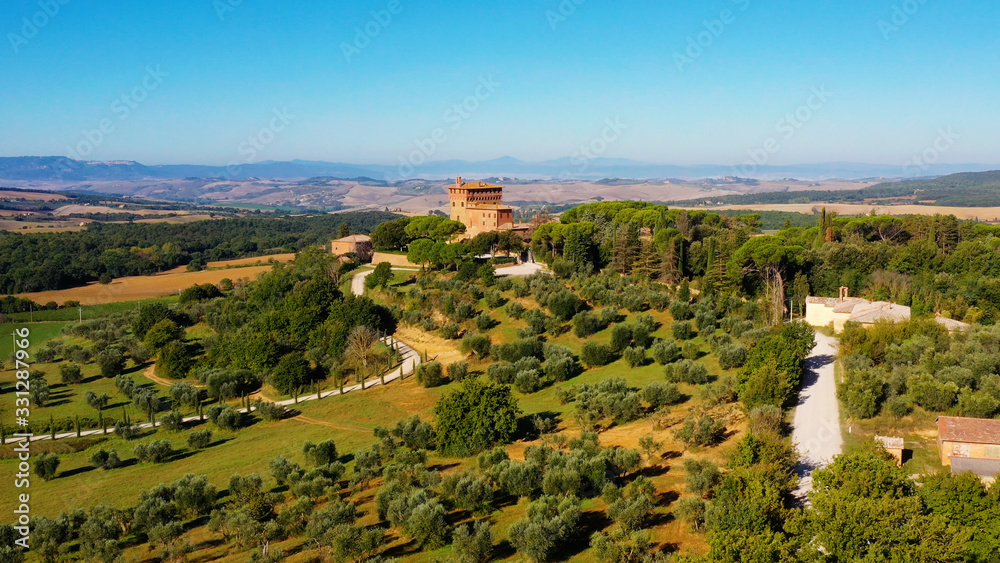 Magnificent authentic Italian villa under the sun. The house is surrounded by green meadows. Aerial view with a drone in Tuscany, Italy